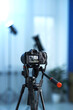© New Africa - Professional video camera with tripod in modern studio