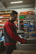 © Wavebreak Media - Man operating pneumatic tool on metal sheet at factory workbench with safety glasses, copy space