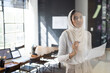 © Wavebreak Media - Indian woman brainstorming on glass wall in conference room, with marker pen and paper, copy space