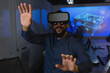 © Wavebreak Media - Man wearing VR headset in conference room interacting with interface on projection screen
