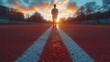 © Muamanah - Sunset Runner: Silhouette of a person jogging on a running track at sunset.