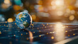 © Rachakrit - Earth globe on solar panel with bright bokeh background, symbolizing renewable energy and sustainability
