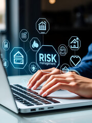Person typing on a laptop with transparent holographic icons related to risk, management, and safety displayed in front of them.