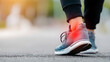 © Kanomaoi - A close-up shot of an athlete suffering from an ankle injury, the area highlighted in red against a blurred background