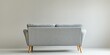 © Pech - A back view of a stylish grey modern sofa with wooden legs against a plain background.