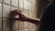 © jaha - Hand Pressing a Button on a Tiled Wall