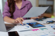 © crizzystudio - Businesswoman is working with financial documents, using calculator and analyzing charts in modern office, performing accounting and financial analysis