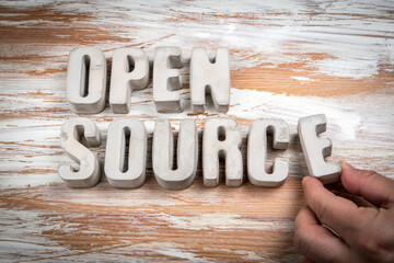 Wall Mural - open source. concrete alphabet letters on a light painted wood texture background