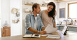 © peopleimages.com - Home, payment and couple with documents, smile and budget for mortgage, rent and love. Apartment, finance or man with woman in kitchen, tax return or paperwork report for savings or investment growth