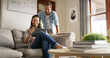 © BuyoutReese10/peopleimages.com - Discount, couple and woman with card, tablet and browsing for online shopping in living room or happy. House, man and spouse with tech for digital purchase, scroll or people with credit for ecommerce