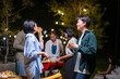 © Wasana - A group of people are gathered around a barbecue, enjoying each other's company