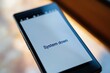 © Oleksandr - Smartphone screen displaying system down message in a modern environment