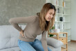 © Shisu_ka - beautiful woman holding her lower back while and suffer from unbearable pain health and problems, chronic back pain, backache in office syndrome, scoliosis, herniated disc, muscle inflammation
