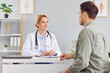 © Studio Romantic - Serious female smiling doctor explaining healthcare examination result to male patient in medical clinic, speaking, healthcare practitioner giving consultation during hospital meeting, showing support