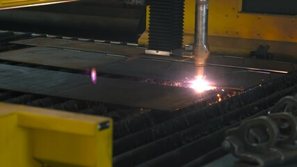 Poster - Watch as advanced laser cutting technology shapes metal sheets into intricate parts. Sparks fly in this powerful process taking place in a high-tech fabrication facility.
