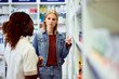 © bnenin - Customer Discussing Product Options with Female Pharmacist in Modern Pharmacy Setting
