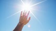 © Cariszzzz - Reaching for the Sun: A hand is reaching towards the bright sun in a cloudless, clear blue sky, evoking feelings of warmth, aspiration and the wonder of nature.