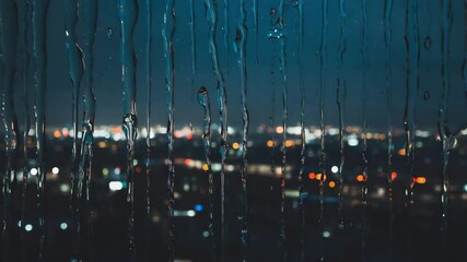 Aufkleber - Light rain on a windowpane with blurred city lights.

