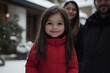 © Erzsbet - Happy Girl in Red Coat Outside Snowy Mansion with Family