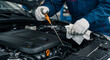 © abu - Close Up of Mechanic Checking Oil Level in Car Engine with Blue Uniform and Gloves