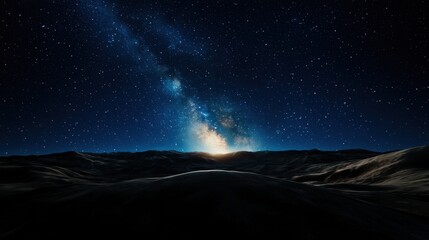 Wall Mural - Stars twinkle brightly in the night sky as the Milky Way arches over a tranquil, dark landscape. The horizon glows softly with cosmic light, creating a serene atmosphere