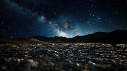 Wall Mural - A mesmerizing view of a starry night sky illuminates a desert landscape. The silhouette of distant mountains contrasts beautifully with the twinkling stars above