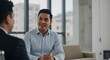 © Lari - Collaborative Dialogue: Two colleagues, engaged in a lively conversation, appear deep in discussion within a modern office setting, illuminated by the natural light of a large window.