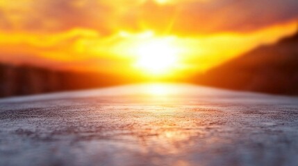 Wall Mural - close-up of road with setting sun and clouds in sky