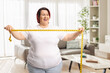 © Ljupco Smokovski - Happy overweight woman holding a measure tape
