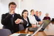 © JackF - Sleepy businessman looking at his wrist watch and yawning during conference in meeting room.