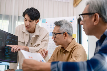 Group of asian senior in a collaborative software development analyzing  flowcharts  during a bootcamp training