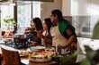 © Drobot Dean - A group of young Indian women is cooking in a bright kitchen, preparing dinner, wearing aprons and traditional attire, smiling, and enjoying the cooking process with fresh ingredients and utensils.