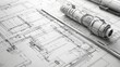 © Vangly - Detailed architectural blueprints with a rolled plan and drafting tools.