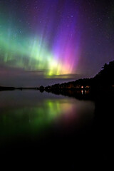 amazing aurora borealis in the starry night . farnebofjarden national park in north of sweden