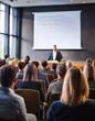 © LIGHTFIELD STUDIOS - Audience attentively watches as a presenter shares innovative ideas in a corporate setting.