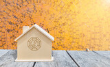 Miniature with Feng Shui symbol on wooden table over ancient wooden Chinese compass background, buy new house, property and real estate business concept 