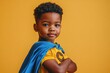 © vasyl pshyk - Cute African American boy embodies superhero spirit, striking a cool pose in front of a bright yellow backdrop during a fun studio photoshoot