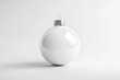 © Jarvis - A glossy, blank white holiday ornament, perfectly centered on a plain background.