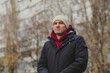 © Anton Dios - Man in winter coat looking thoughtfully at urban surroundings during chilly afternoon