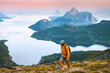 © EVERST - Man backpacker hiking solo in mountains of Norway travel climbing adventure outdoor, healthy lifestyle summer vacations tour active traveler roam alone enjoying sunset islands and sea landscape