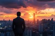 © Igor - Businessman watching city skyline at sunset