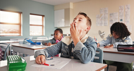 Poster - Tired, child and student in classroom for education lesson, learning burnout and elementary school. Boy, yawn and bored with fatigue for knowledge, overworked and studying brain fog for exam pressure