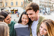 © Xavier Lorenzo - Young group of happy people enjoying time together at city street. Millennial generation friends having fun, laughing while enjoying holiday trip. Friendship and youth concept