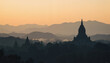 © Anatoly - Historic temple silhouette at dawn over misty hills, peaceful serenity