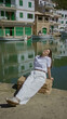 © Krakenimages.com - Woman relaxing by sunny mediterranean port in cala figuera mallorca enjoying serene seascape surrounded by traditional boats and charming seaside architecture.