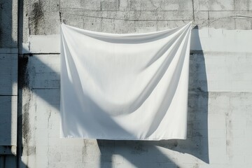 Fototapete - Draped white fabric against a textured wall with shadows creating a simple, clean, and abstract composition.