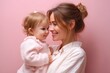 © Dzikrul Husnani - Mother and Baby Girl Smiling on Pink Background