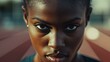 © sitifatimah - Black woman stares intensely, determination radiating, focused athlete embodies strength, competition, intense sport.