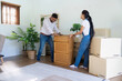 © itchaznong - Moving home couple organizing furniture and boxes in new living room