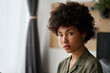 © insta_photos - Young pretty calm confident 20 years African American woman student with afro hair, attractive face sitting at home or in office looking at camera, close up headshot portrait.